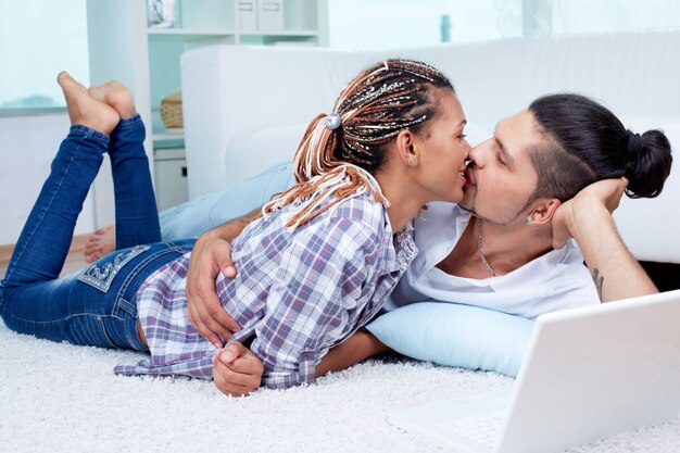 Couple lying on the floor and kissing