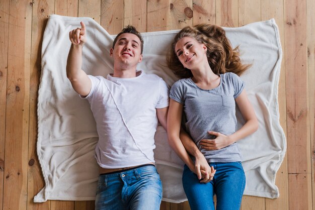 Couple lying on floor and looking up