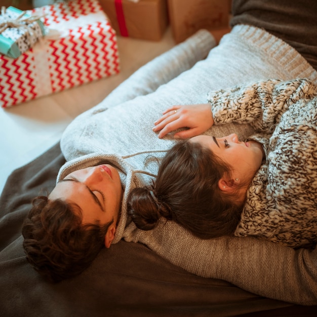 Couple lying at present boxes 