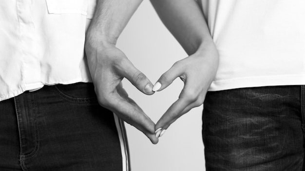 Couple making heart from hands 