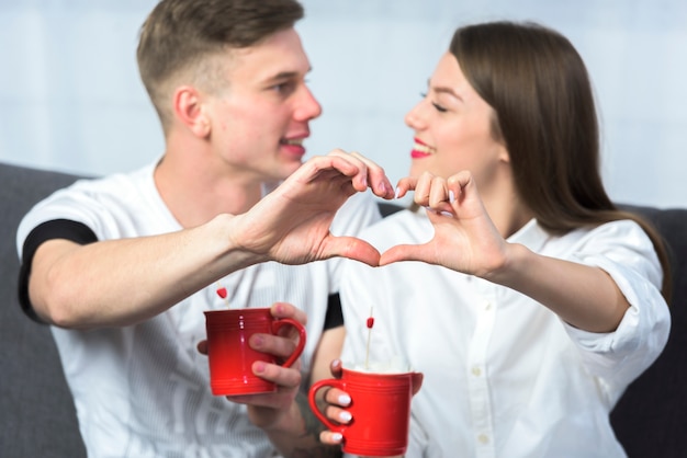 Couple making heart shape with hands 