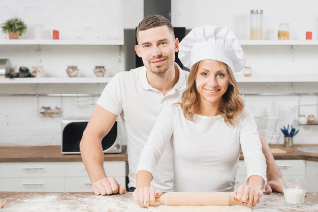 Couple making pizza dough