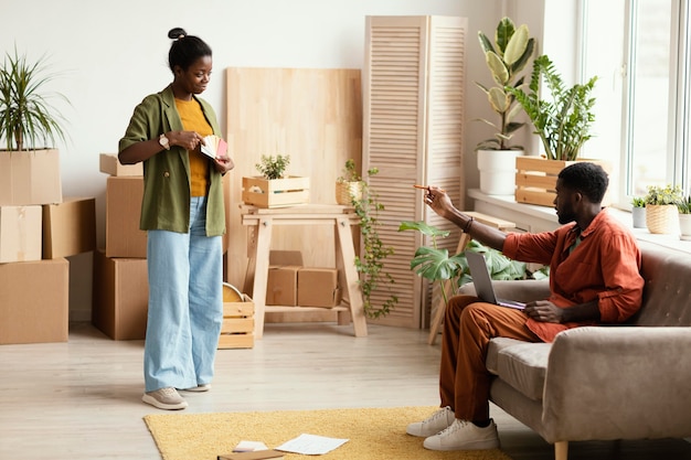 Couple making plans for renovating home using laptop and color palette