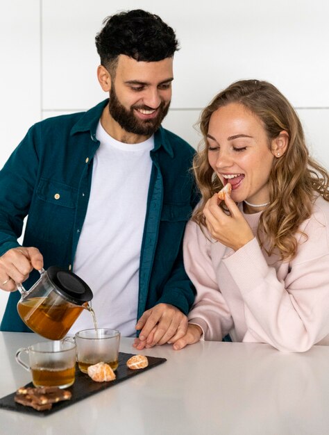 Couple making tea at home together
