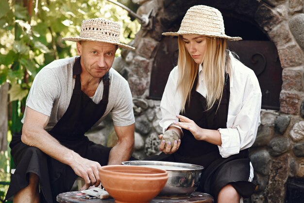 Couple making a vase with clay