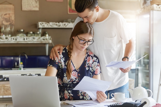 Couple managing budget together in kitchen