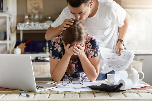 couple managing budget together in kitchen