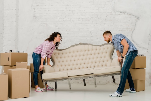 Couple moving sofa