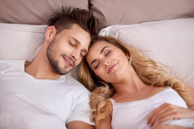 Couple napping in the bedroom