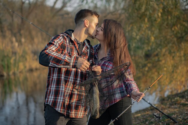 Couple near river in a fishing morning