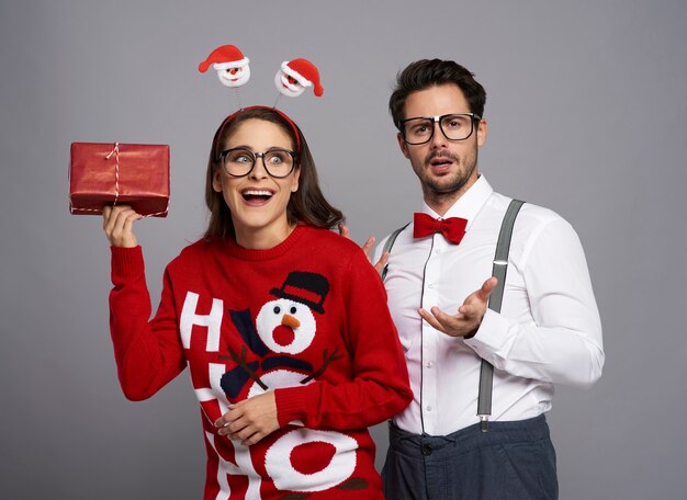 Couple of nerds posing on gray wall