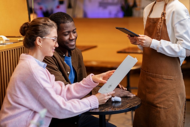 Couple ordering food at restaurant