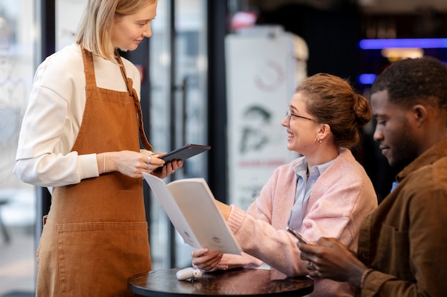 Couple ordering food at restaurant