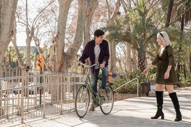 Couple outside for a walk with bicycle