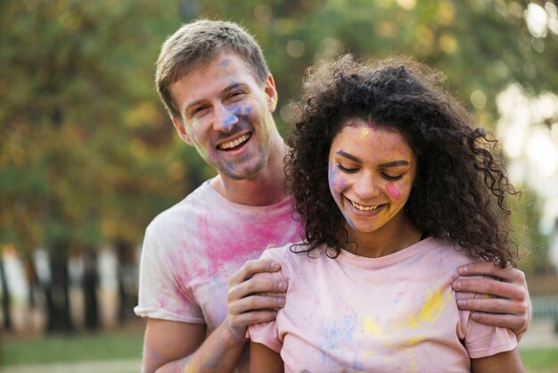 Couple painted with color posing at holi