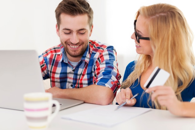 Couple paying bills by credit card