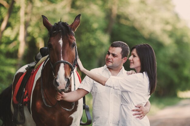 Couple petting a horse