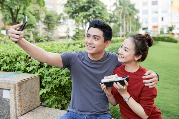 Couple photographing with street food