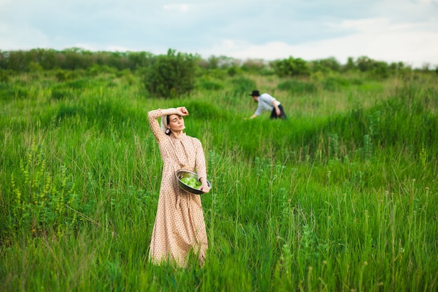 Couple picking fruits in the meadow