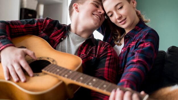 Couple playing guitar