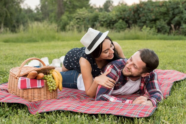 Couple playing on a picnic blanket