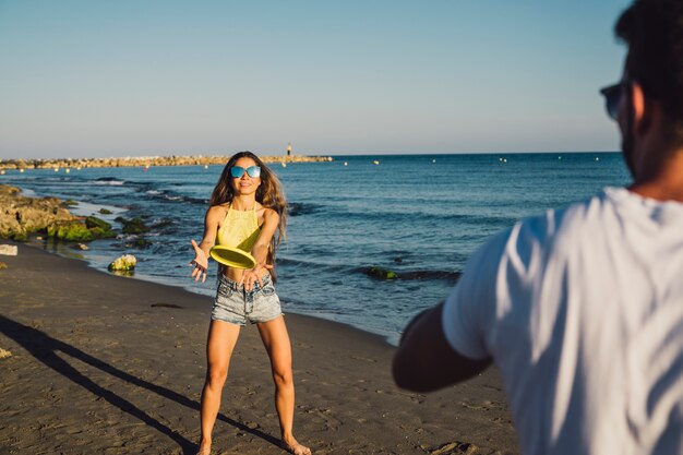 Couple playing ping pong at the beach