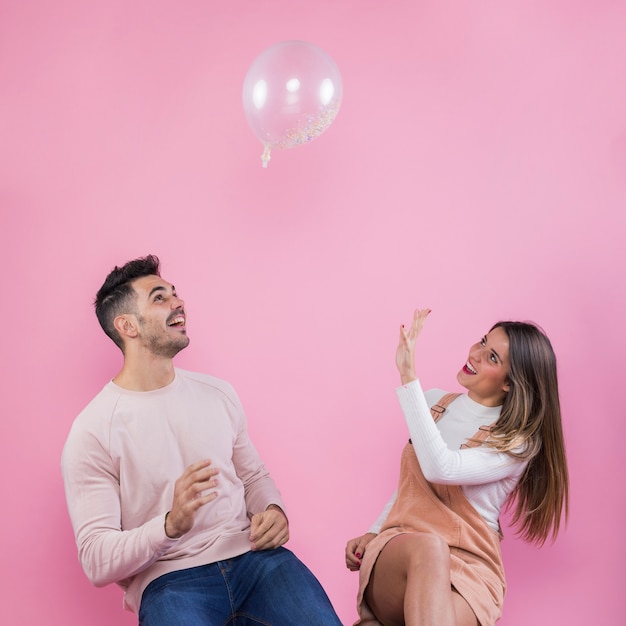 Couple playing with air balloon 