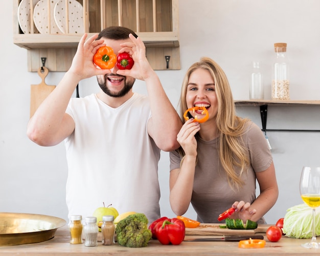 Couple playing with bell pepper