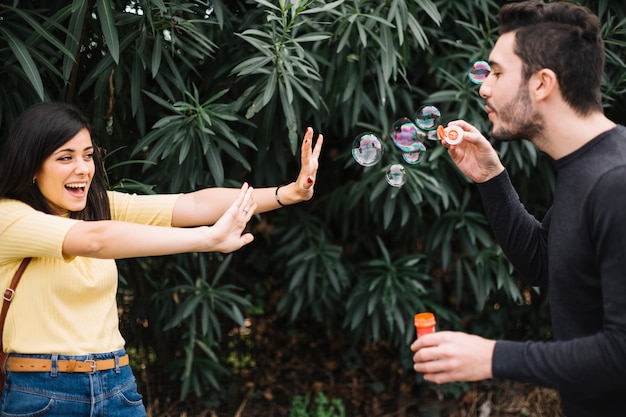 Free photo couple playing with bubbles