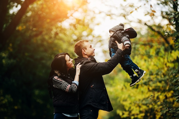 Couple playing with child in park