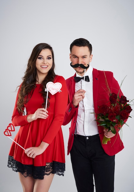 Couple playing with masks in the studio