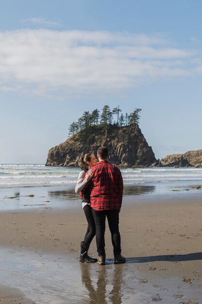 Couple posing embraced on shore