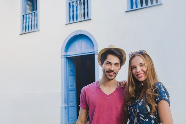 Couple posing in front of house