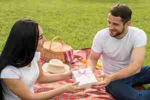 Foto gratuita coppie che posano su una coperta da picnic