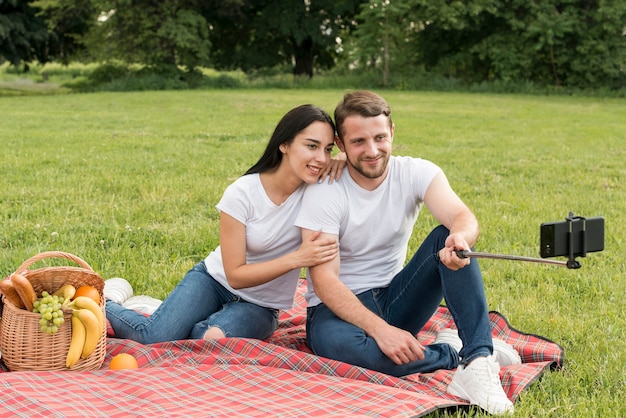 Couple posing on a picnic blanket