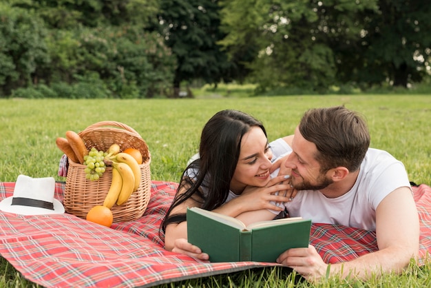 Couple posing on a picnic blanket