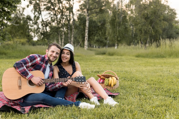 Couple posing on a picnic blanket