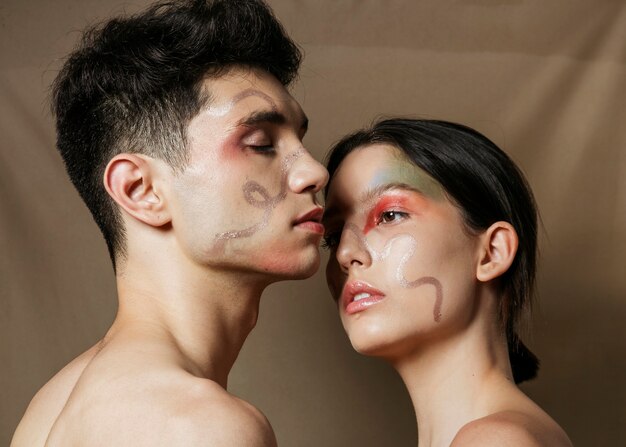 Couple posing seductively with painted faces