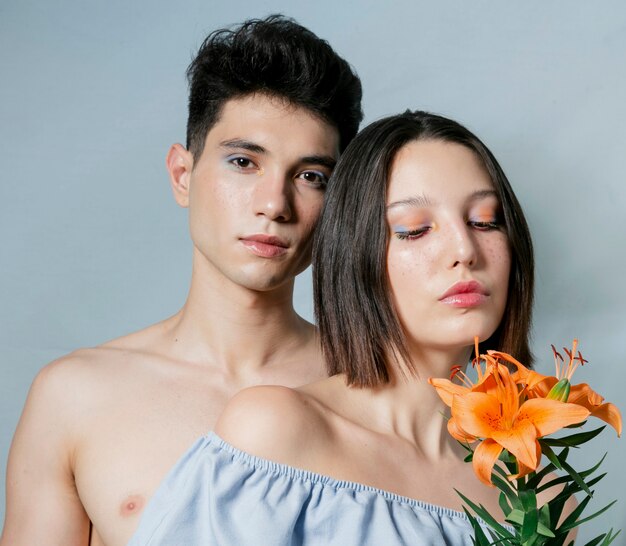 Couple posing and smelling lily