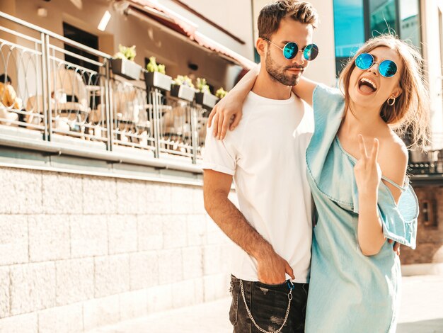 Couple posing on the street in sunglasses