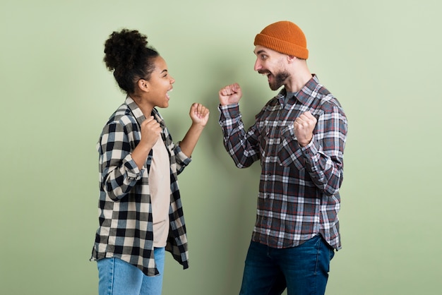 Free photo couple posing victoriously