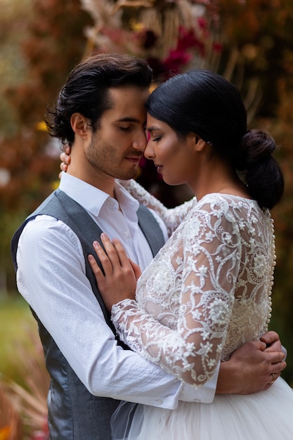 Couple posing at wedding side view