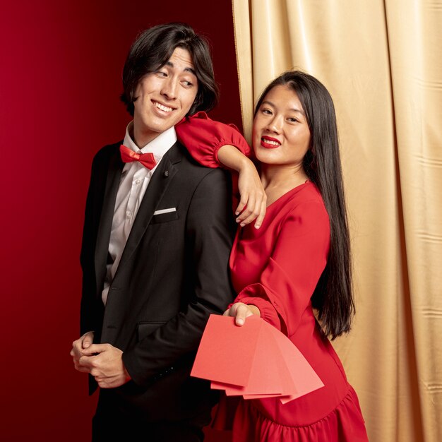 Couple posing with red envelopes for chinese new year