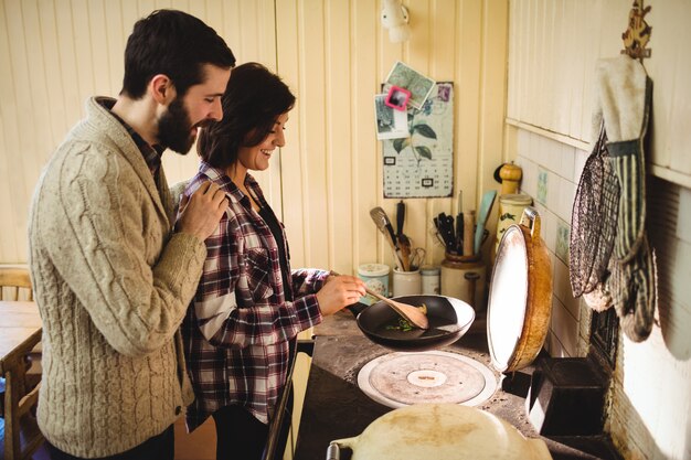 Couple preparing food together in kitchen