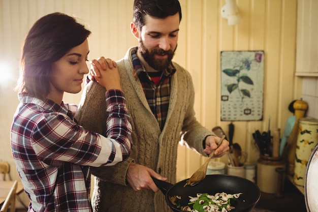 Couple preparing food together in kitchen