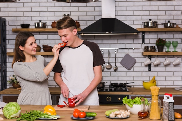 Couple preparing fresh vegetables together at home