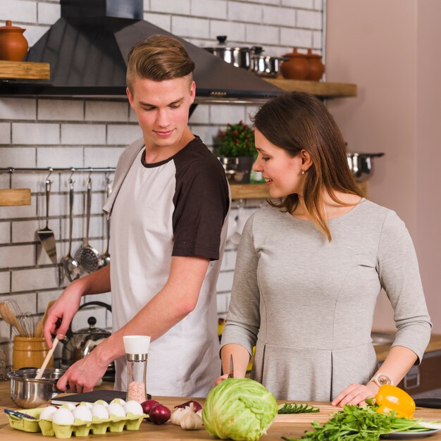 Couple preparing meal in kitchen