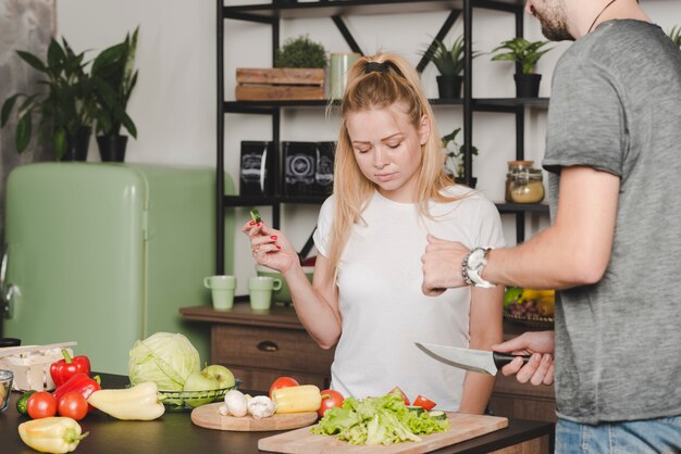 Couple preparing vegetable in kitchen together