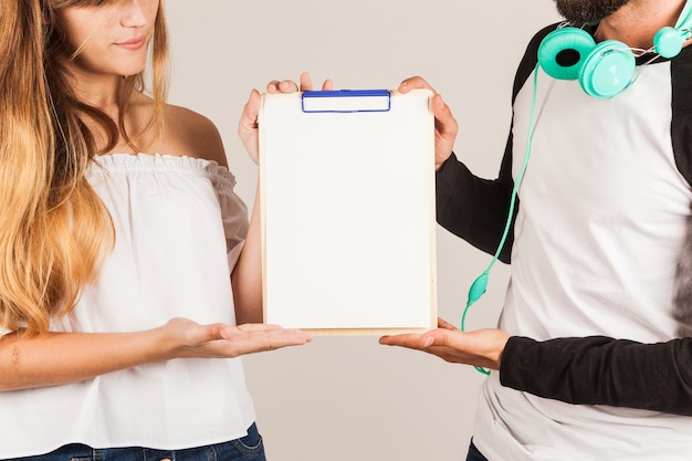 Free photo couple presenting clipboard