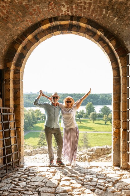 Couple raising their hands in the air in front of a door